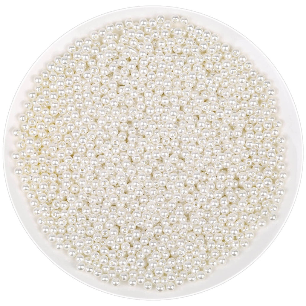 Ivory acrylic pearl beads with holes for jewelry making, shown in a white bowl.
