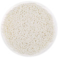 Ivory acrylic pearl beads with holes for jewelry making, shown in a white bowl.