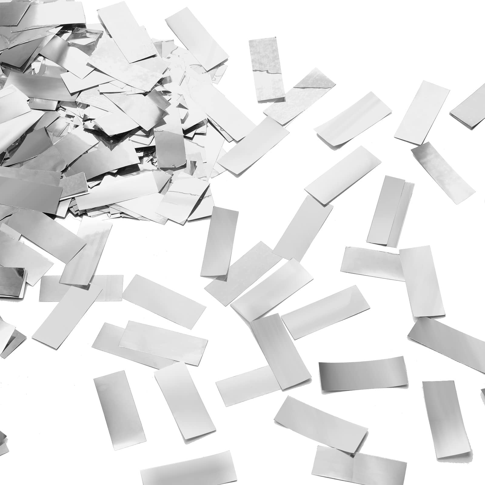 Pile of silver foil confetti scattered on a white background, showing rectangular pieces of varying sizes and orientations.
