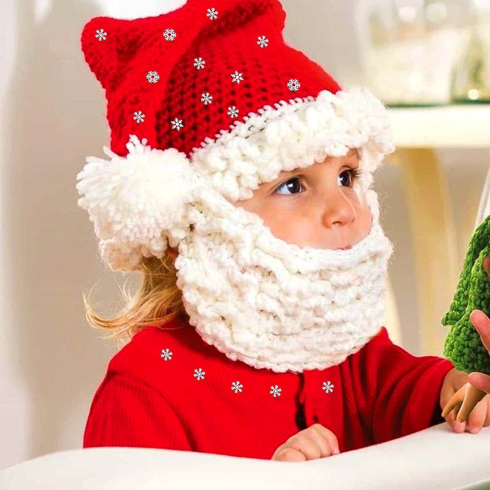 Child wearing a red Santa hat with white trim and a knitted beard, looking to the side.