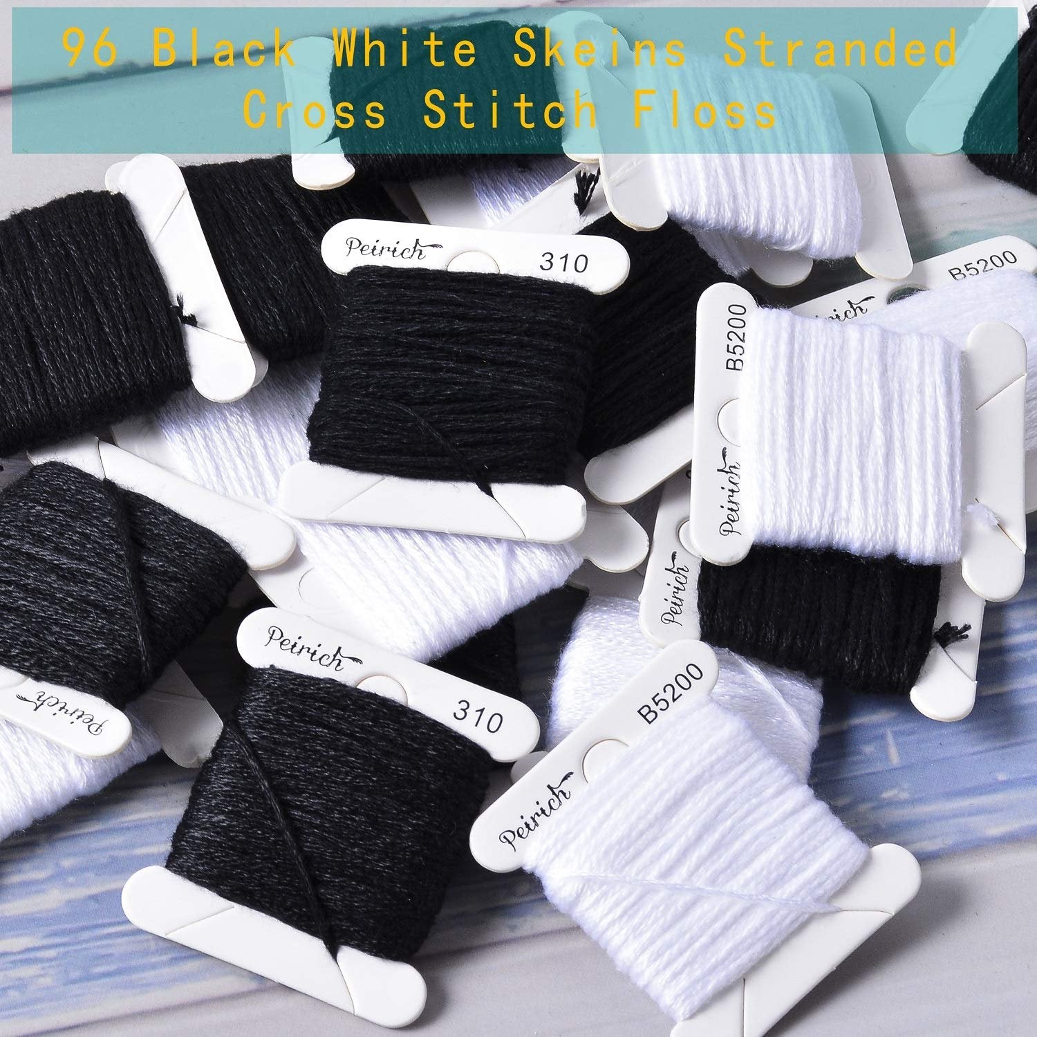 Close-up of black and white embroidery floss skeins wound on bobbins, some labeled.
