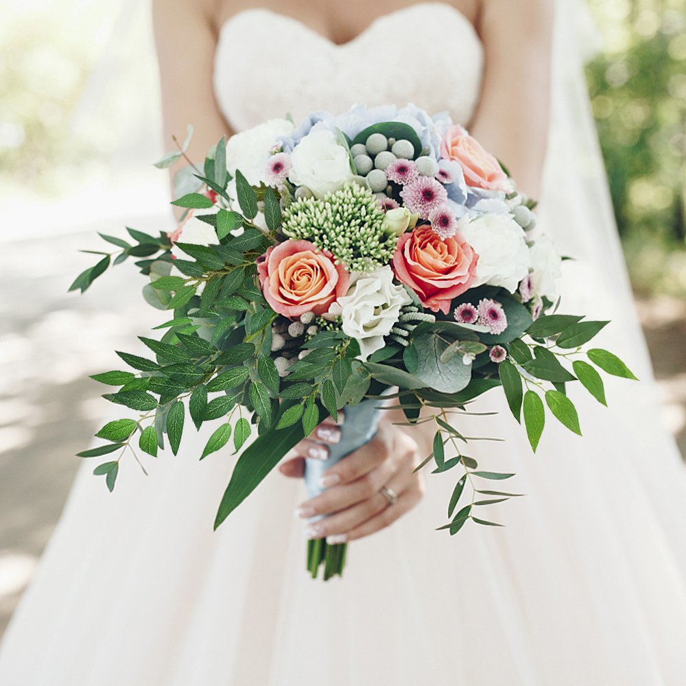 Bride holding a bouquet of artificial Italian ruscus greenery stems and flowers