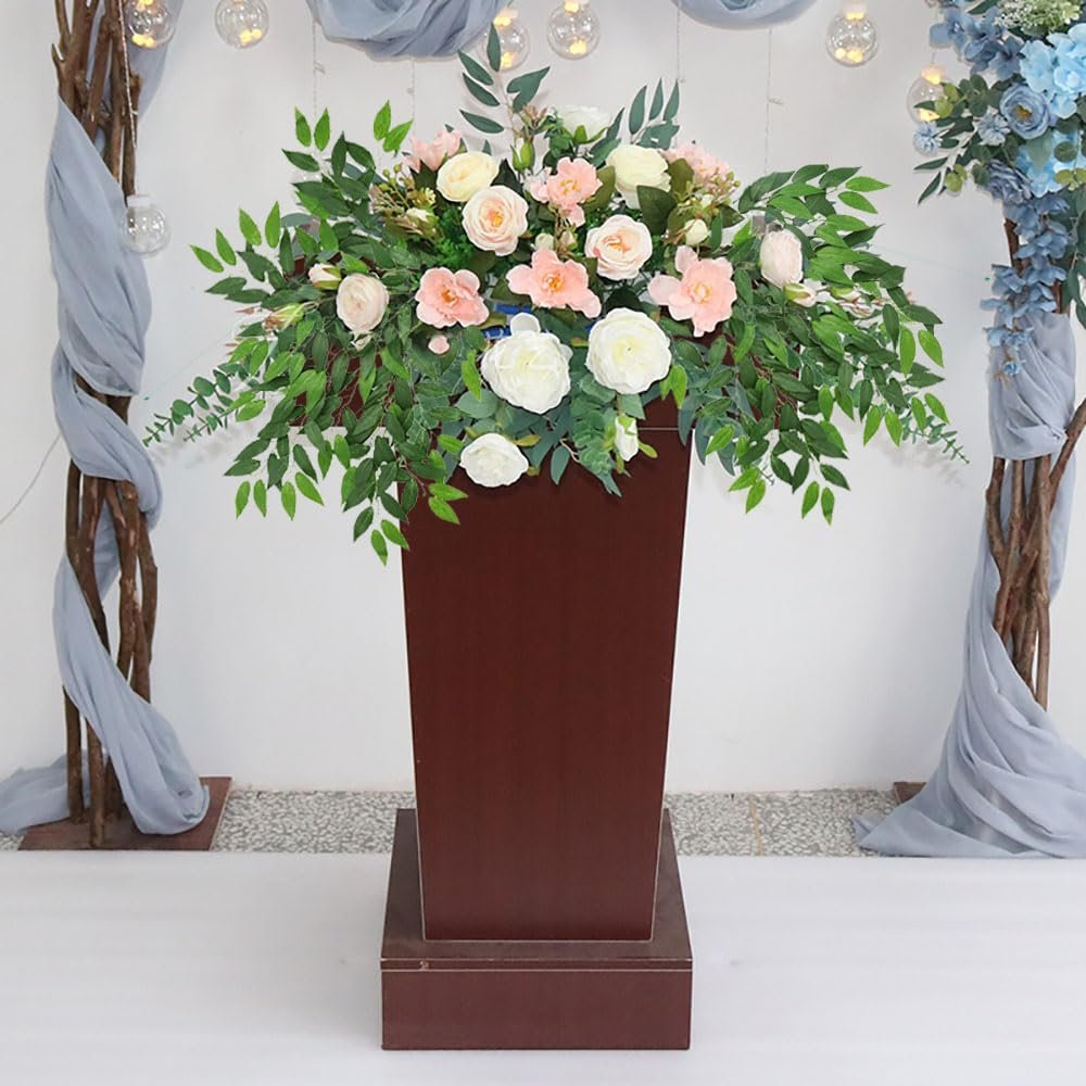 Artificial Italian Ruscus greenery stems with pink and white roses in a tall brown vase.