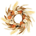 Artificial fall wreath with white pumpkins, orange flowers, and autumn leaves on a white background.