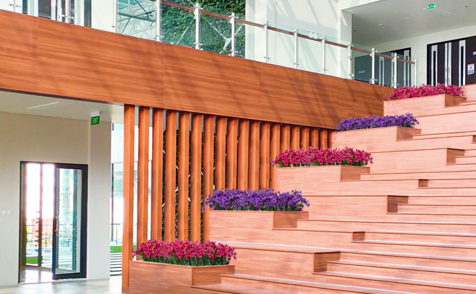 Artificial purple and pink flowers in planters on a modern wooden staircase