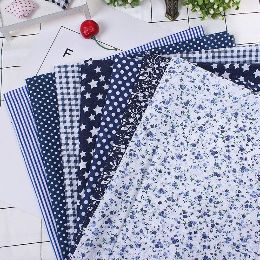 Assortment of floral printed cotton fabric squares in navy blue, grey, and black patterns.