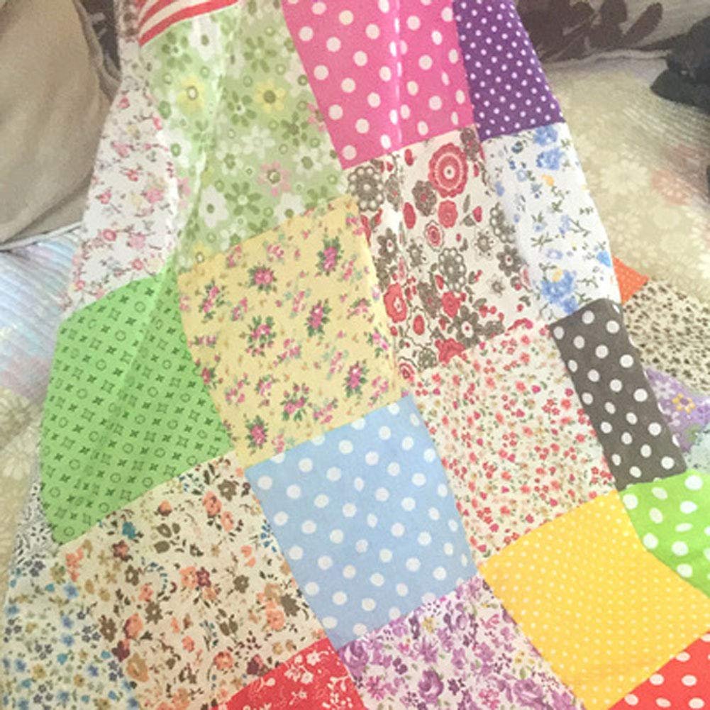 Close-up of a patchwork quilt made of various floral and polka dot fabric squares in assorted colors.