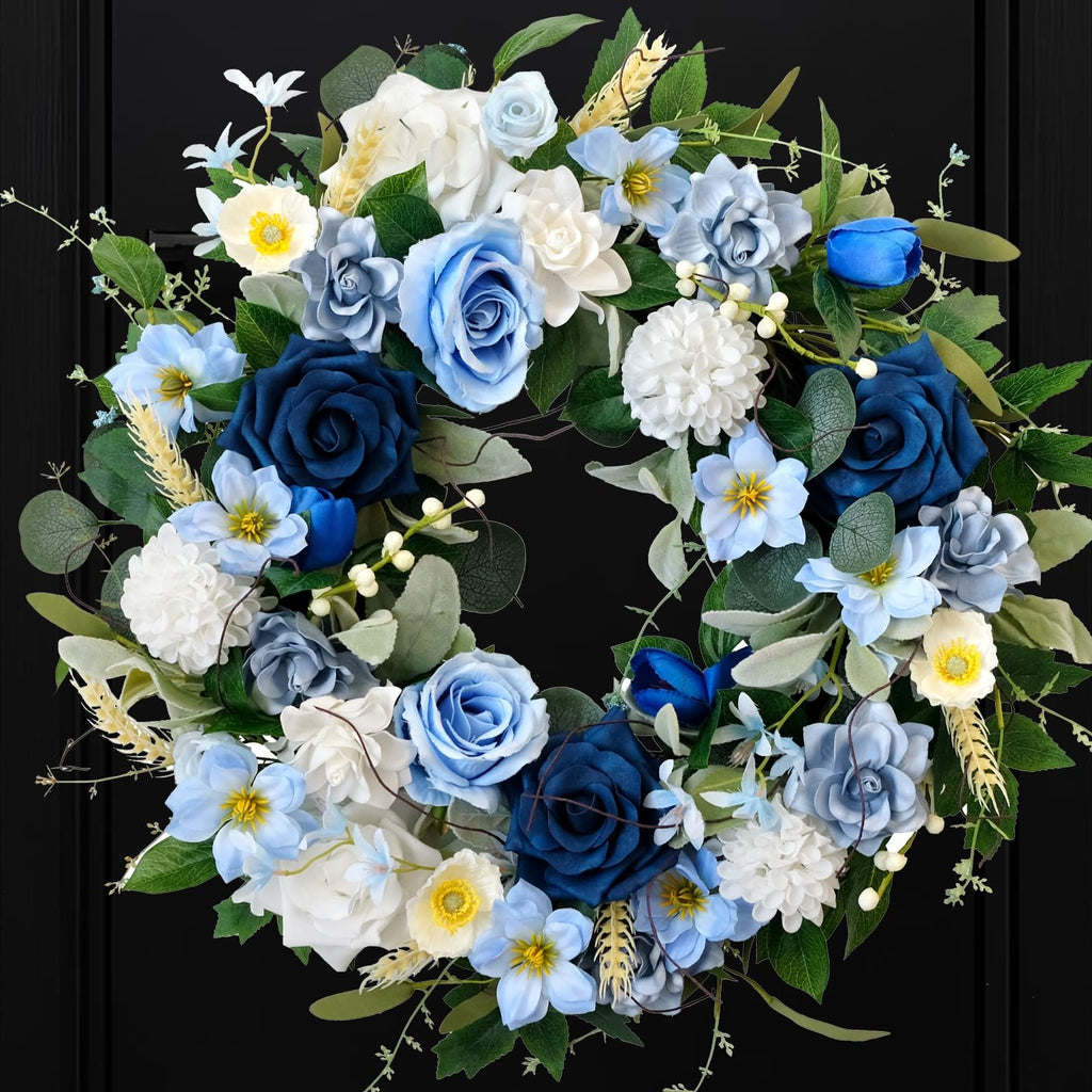 Blue and white artificial floral wreath with roses, dahlias, and hydrangeas on a black background.