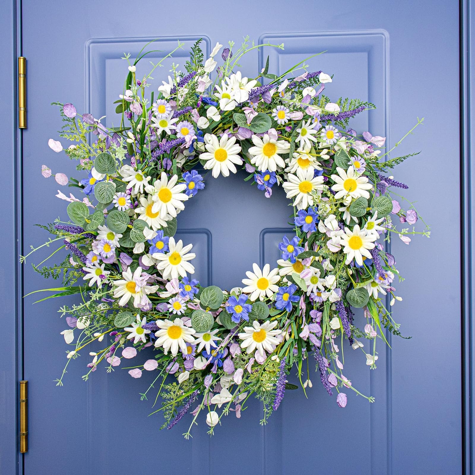 22-inch blue summer wreath with daisies, lavender, wildflowers, and eucalyptus hanging on a blue door.