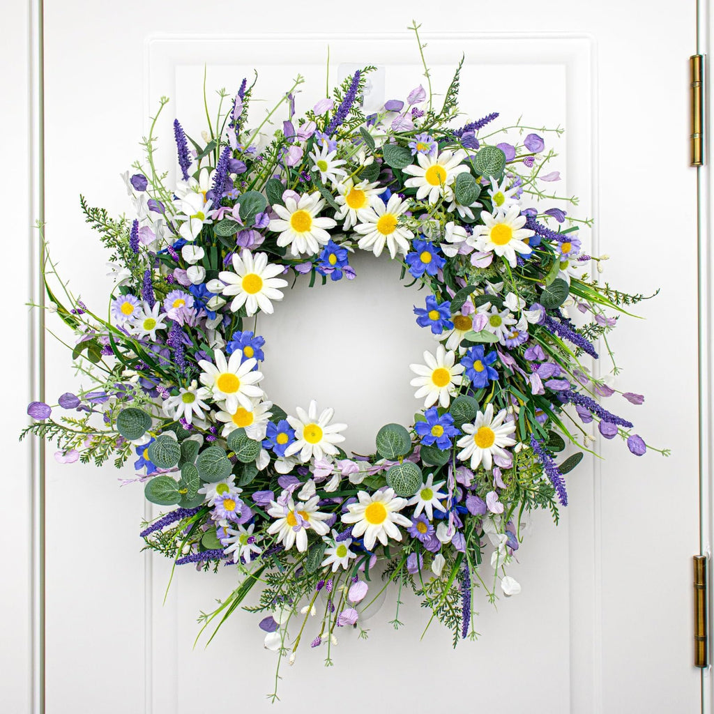 22-inch blue summer wreath with daisies, lavender, wildflowers, and eucalyptus hanging on a white door.