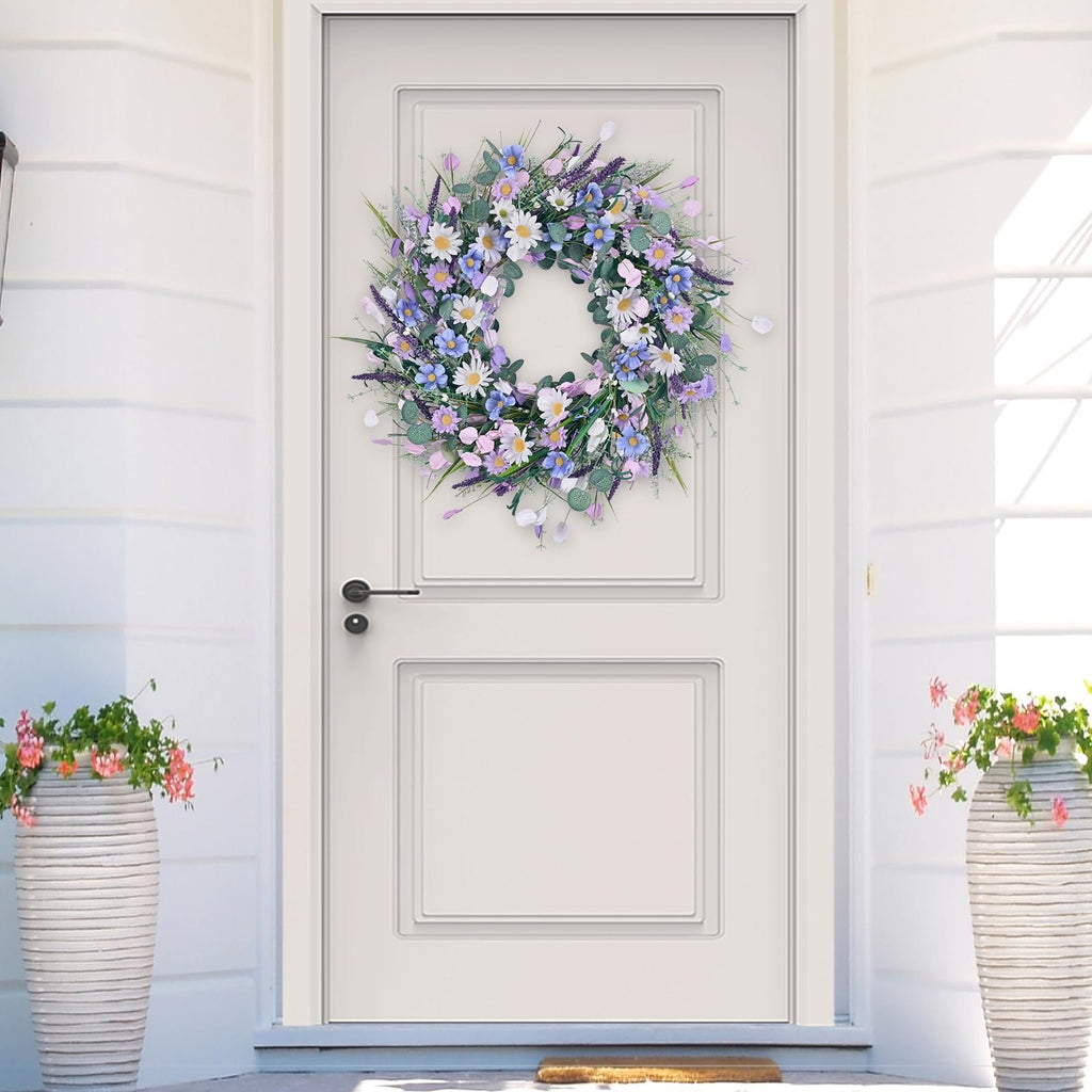 Spring daisy wreath with lavender and eucalyptus hanging on a white front door