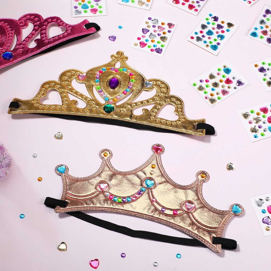 Three princess crowns and sheets of crystal diamond stickers on a pink background