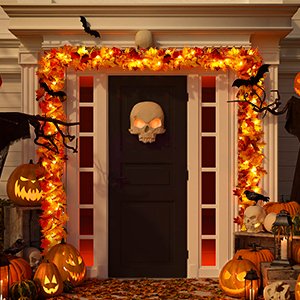 Front door decorated for Halloween with a maple leaf garland and pumpkins.