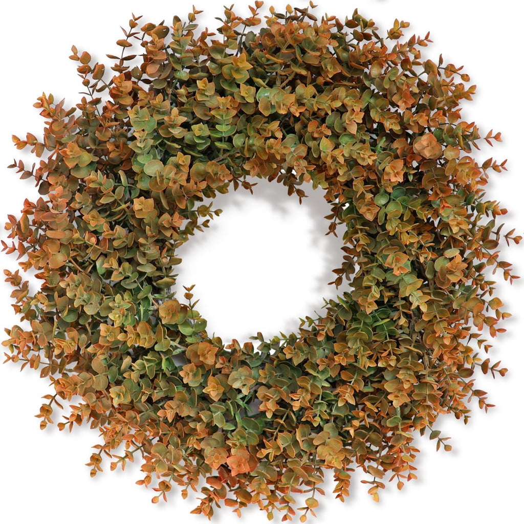 Artificial boxwood wreath with green and brown leaves, displayed against a white background.