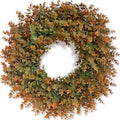 Artificial boxwood wreath with green and brown leaves, displayed against a white background.