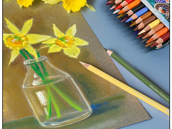 Pastel charcoal pencils and a drawing of daffodils in a glass vase