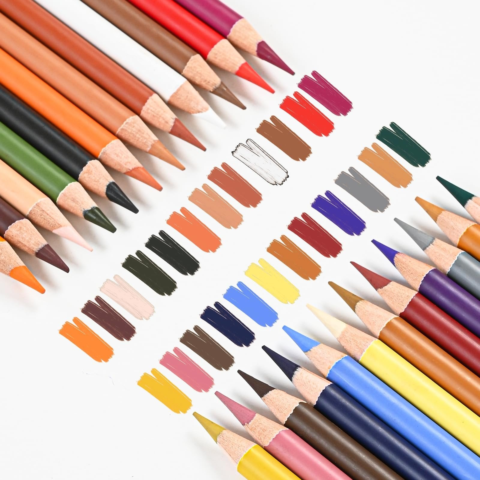 Pastel charcoal drawing pencils arranged with color swatches on white background