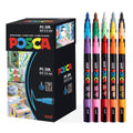 Set of paint markers and their box, showing various colors and artwork on the packaging.