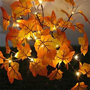 Close-up of an artificial lighted maple tree branch with orange-red leaves and 24 LED lights.