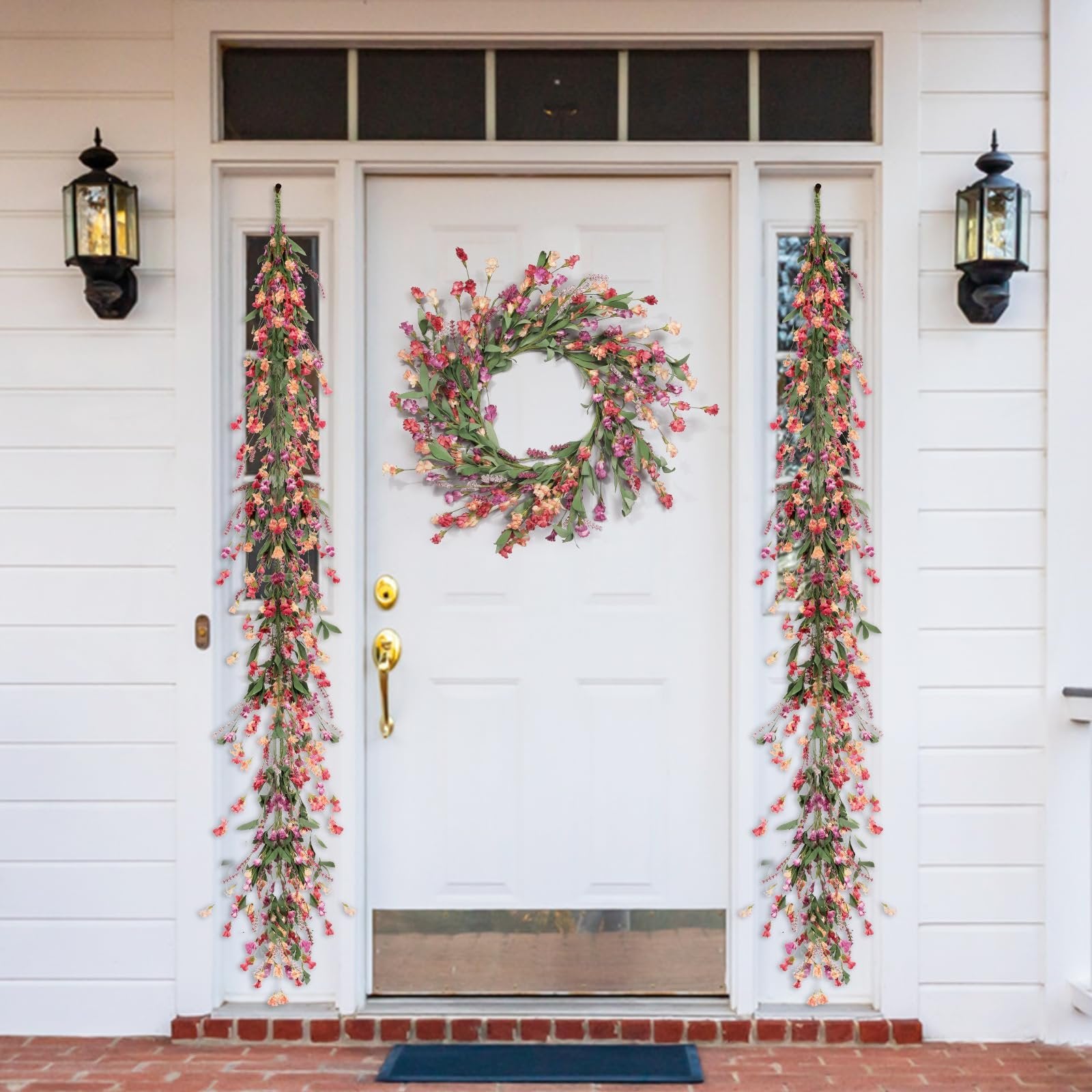 Front door decorated with a floral wreath and two hanging garlands for spring and summer.