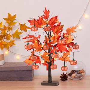 24-inch lighted maple leaves tree with 24 LEDs and 12 wood pumpkin ornaments, displayed on a table with other fall decorations.