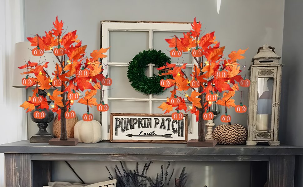 Two lighted maple leaf trees with pumpkin ornaments and 24 LEDs displayed on a mantelpiece with a wreath and sign.