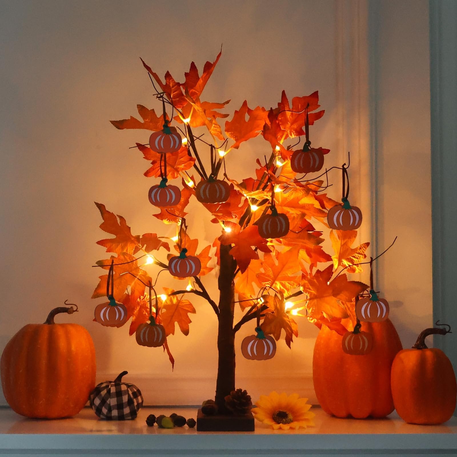 Lighted maple leaves tree with 24 LEDs and 12 wood pumpkin ornaments, displayed with pumpkins and acorns.
