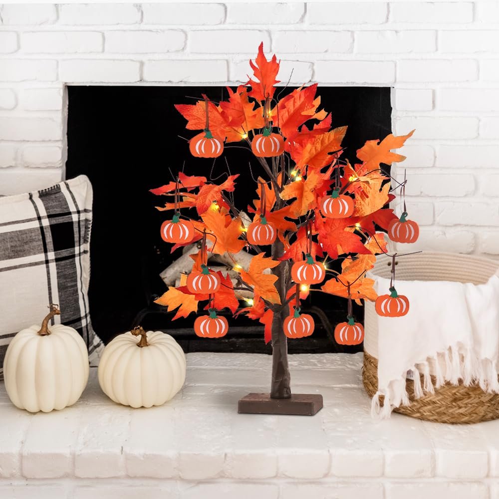 Lighted maple leaves tree with pumpkin ornaments on a mantelpiece with pumpkins and a basket.