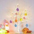 Pre-lit white birch Easter tree with colorful egg ornaments and warm white LED lights, flanked by gnome figures.