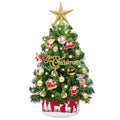 Miniature Christmas tree with gold star topper, ornaments, and LED lights, set against a white background.