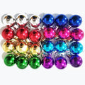 Assortment of 24 mini glitter Christmas ball ornaments in 8 colors, arranged in rows on a white background.