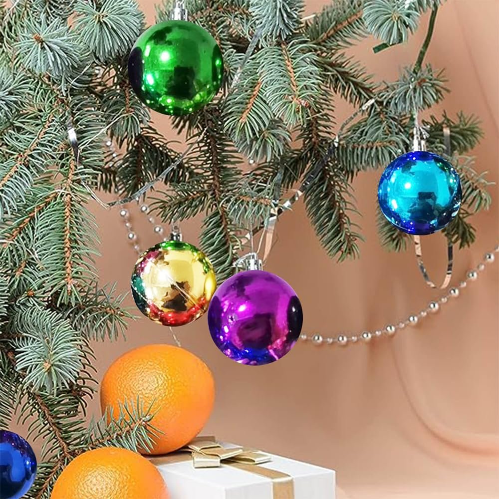 Christmas tree branches with colorful glitter ball ornaments, oranges, and a gift box.