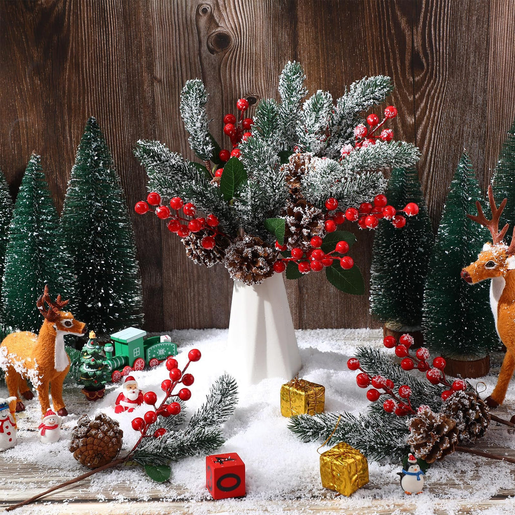 Christmas artificial flower picks with red berries and pine cones arranged with festive decorations on snow