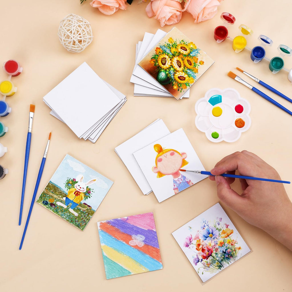 Mini magnetic canvas panels with paint, brushes, and finished artwork, showing a hand painting a canvas.