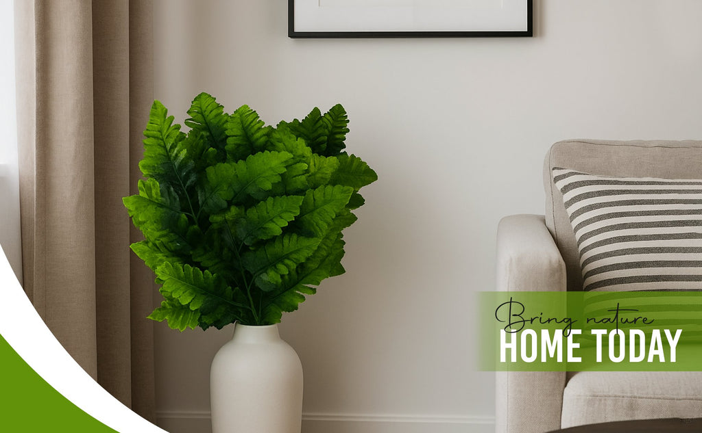 Artificial silk leather leaf fern fronds in a white vase on a table next to a sofa.