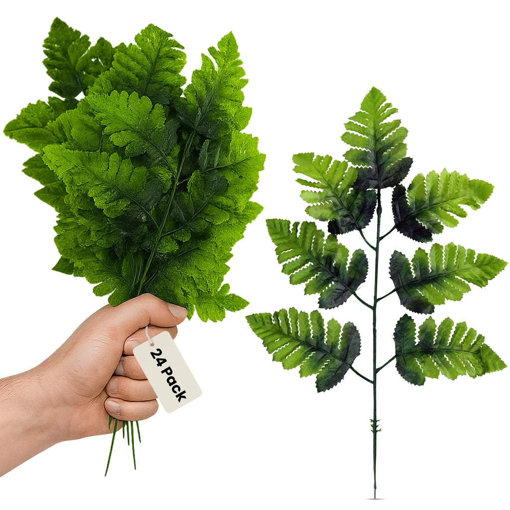 Hand holding a bunch of artificial green fern fronds, with a separate frond shown on the right.