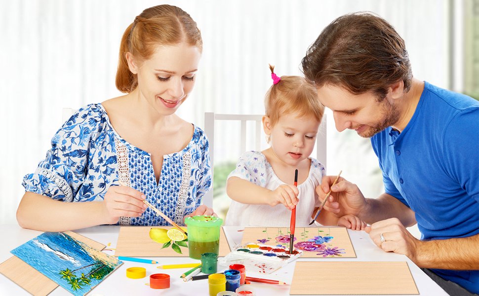 Family painting on thin wood boards, with watercolors and brushes on a table.