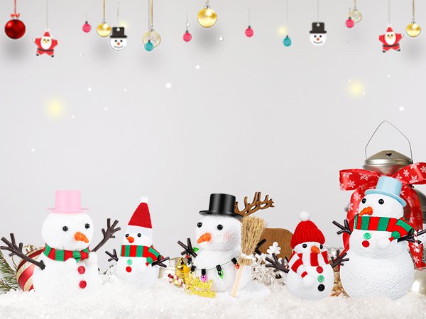 Five decorative snowmen with hats and scarves sit in fake snow, with Christmas ornaments hanging above.