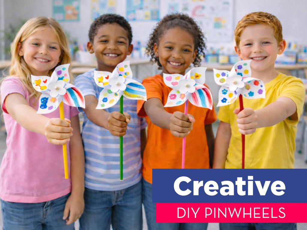 Four smiling children hold up colorful DIY pinwheels they have decorated.
