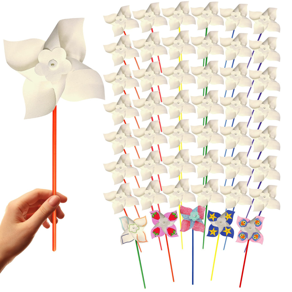 Hand holding a white pinwheel on an orange stick, with a large group of white pinwheels behind it.