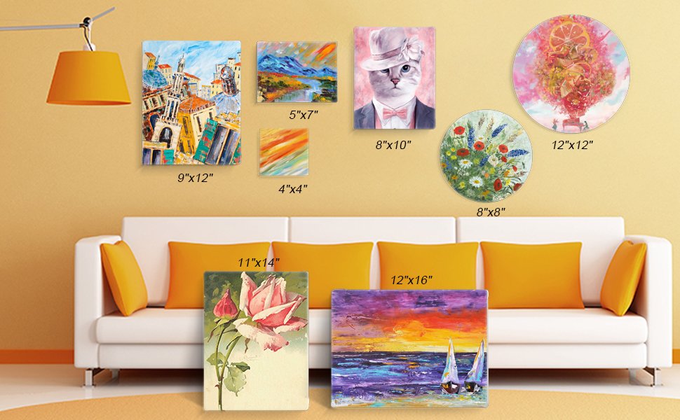 Collection of framed and unframed art canvases displayed on a wall above a sofa, showing various sizes and artwork styles.