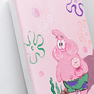 Close-up of a stretched painting canvas with a cartoon character and underwater elements painted on it.