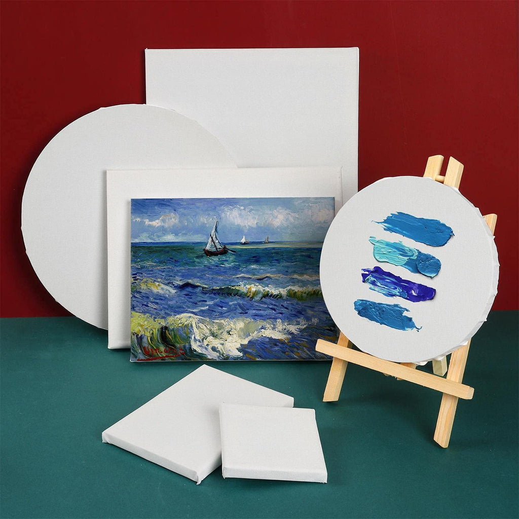 Various stretched painting canvases in different shapes and sizes, with a small painting of a sailboat on the ocean and paint swatches on one canvas.