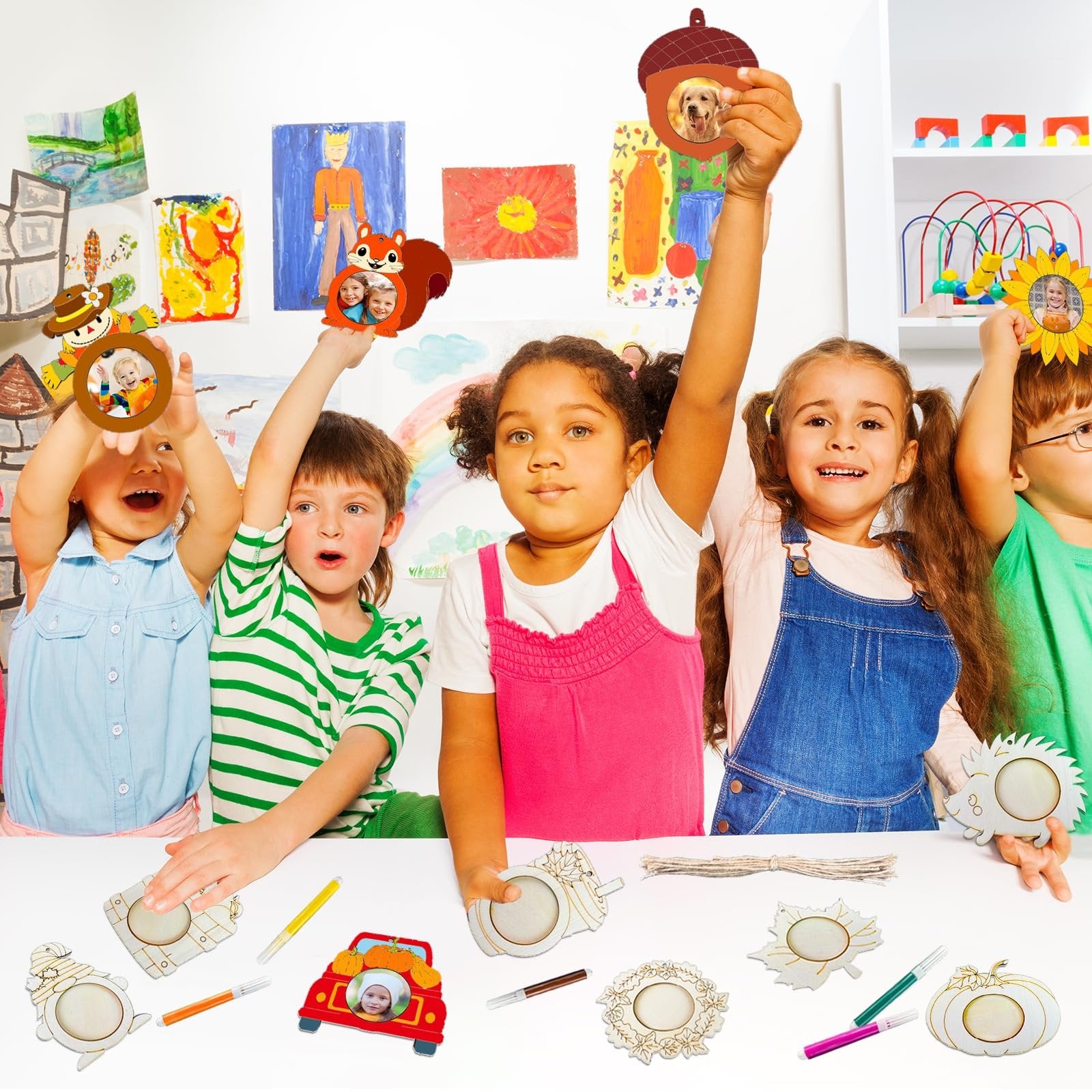 Children holding up unfinished wooden fall picture frame ornaments, including squirrel, acorn, and sunflower shapes.