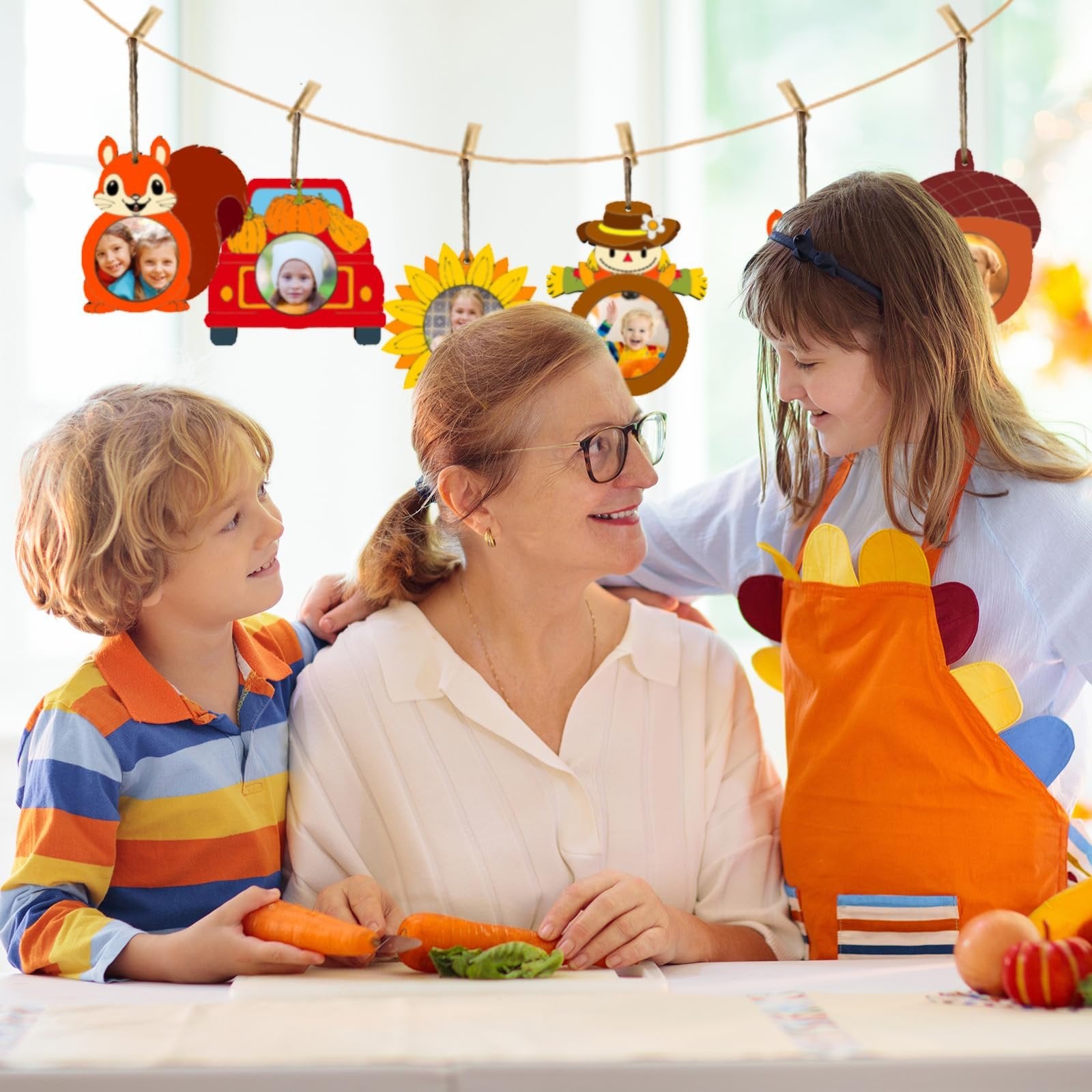 Grandmother and two children crafting fall picture frame ornaments hanging on a clothesline