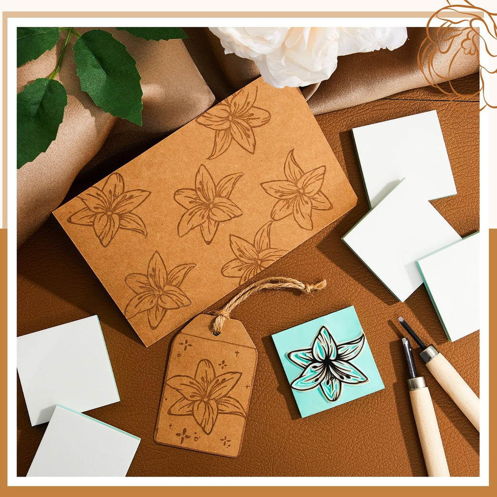 Carving blocks and tools for printmaking, with lily designs on paper tags and a teal block.