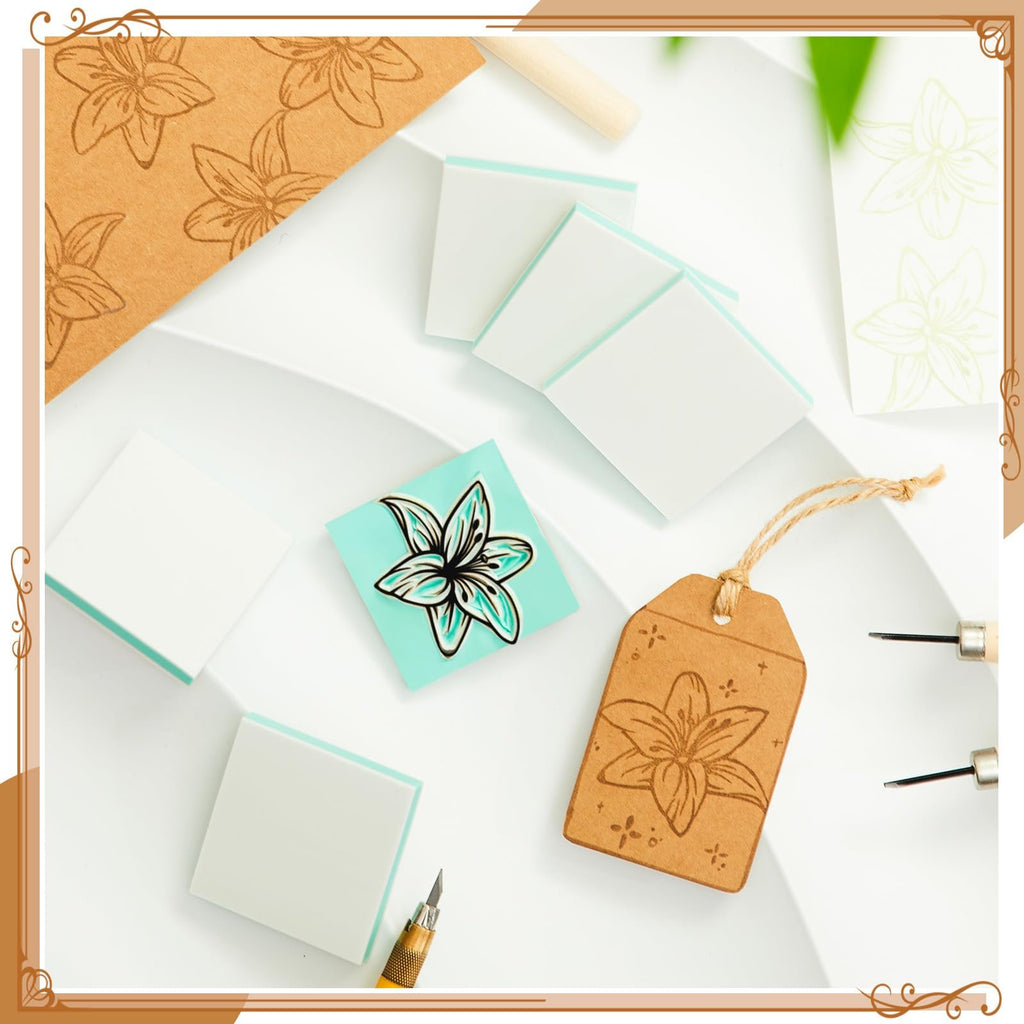 Carving blocks and tools arranged with lily flower designs on paper and a tag