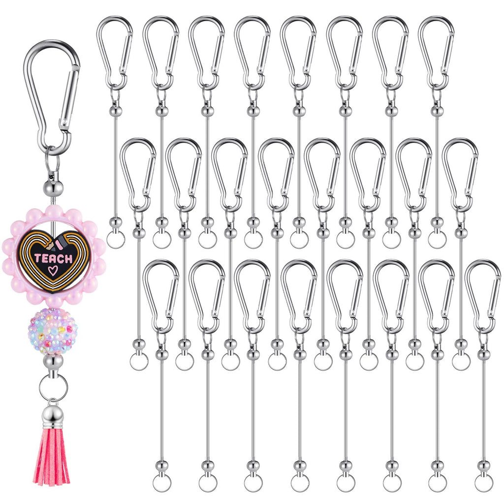 Silver metal keychain bars with snap hooks and one decorative keychain with 'TEACH' text and pink tassel