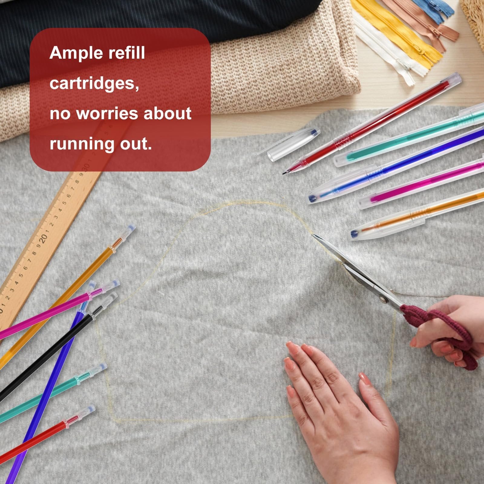 Hands using scissors to cut fabric marked with heat erasable pens, with pens and ruler nearby.