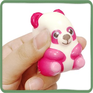 Hand holding a pink and white panda squishy toy with large eyes and pink ears.